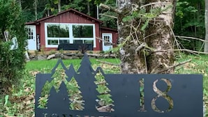 A sign for Johnnys Lane with a mountain silhouette and the number 18.