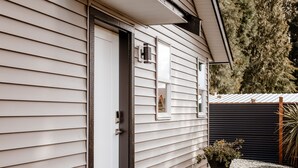 A house with a front door, a small porch, and a gravel driveway. - Private Guest House  -Villa in the Valley- (Nanaimo)