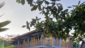 Un edificio a due piani con un balcone al piano superiore.
