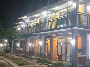 A multi-story hotel with balconies and outdoor seating areas. - Takbo Beach Resort (General Luna)