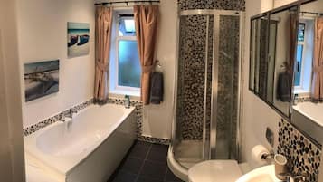 Separate bathtub and shower, deep-soaking bathtub, towels, soap