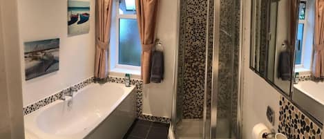 Separate bathtub and shower, deep-soaking bathtub, towels, soap