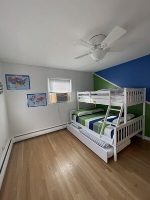 A child’s bedroom with bunk beds, a ceiling fan, and educational posters on the walls. - Home in Stratford (Stratford)