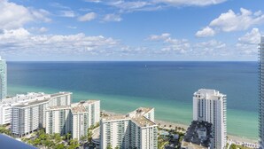 A coastal cityscape with high-rise buildings, a clear blue sky, and a view of the ocean. - <br>★★★★★ Hyde Hotel Condo 2BD/2BA Amazing view and excellent RESSORT (Hollywood)