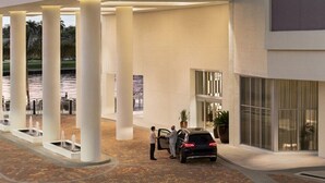 A modern hotel entrance with a covered outdoor area, columns, and a car parked near the entrance. - <br>★★★★★ Hyde Hotel Condo 2BD/2BA Amazing view and excellent RESSORT (Hollywood)