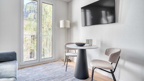 A modern dining area with a round table, two chairs, a bowl, and a lamp. - Sunlit Wiedikon 1 Room w/ Storage & W/D, 1 min to Market, by Blueground (Zurich)
