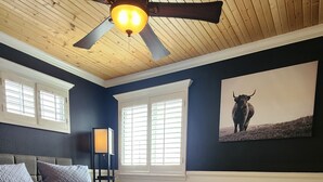 A bedroom with a large bed, wooden flooring, a ceiling fan, and a framed picture on the wall. - Swimming pool, 4 bedroom 2.5 bath + bonus room, outdoor dining and outdoor TV  (El Paso)