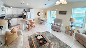 A spacious living area with a kitchen, dining area, and a cozy seating space. - Relaxing Waterfront Escape Near Key West - Venture Out Unit 410 (Cudjoe Key)