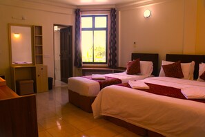 A hotel room with two beds, a desk, a mirror, and a window with curtains. - ONE ON INN (Maradhoo)
