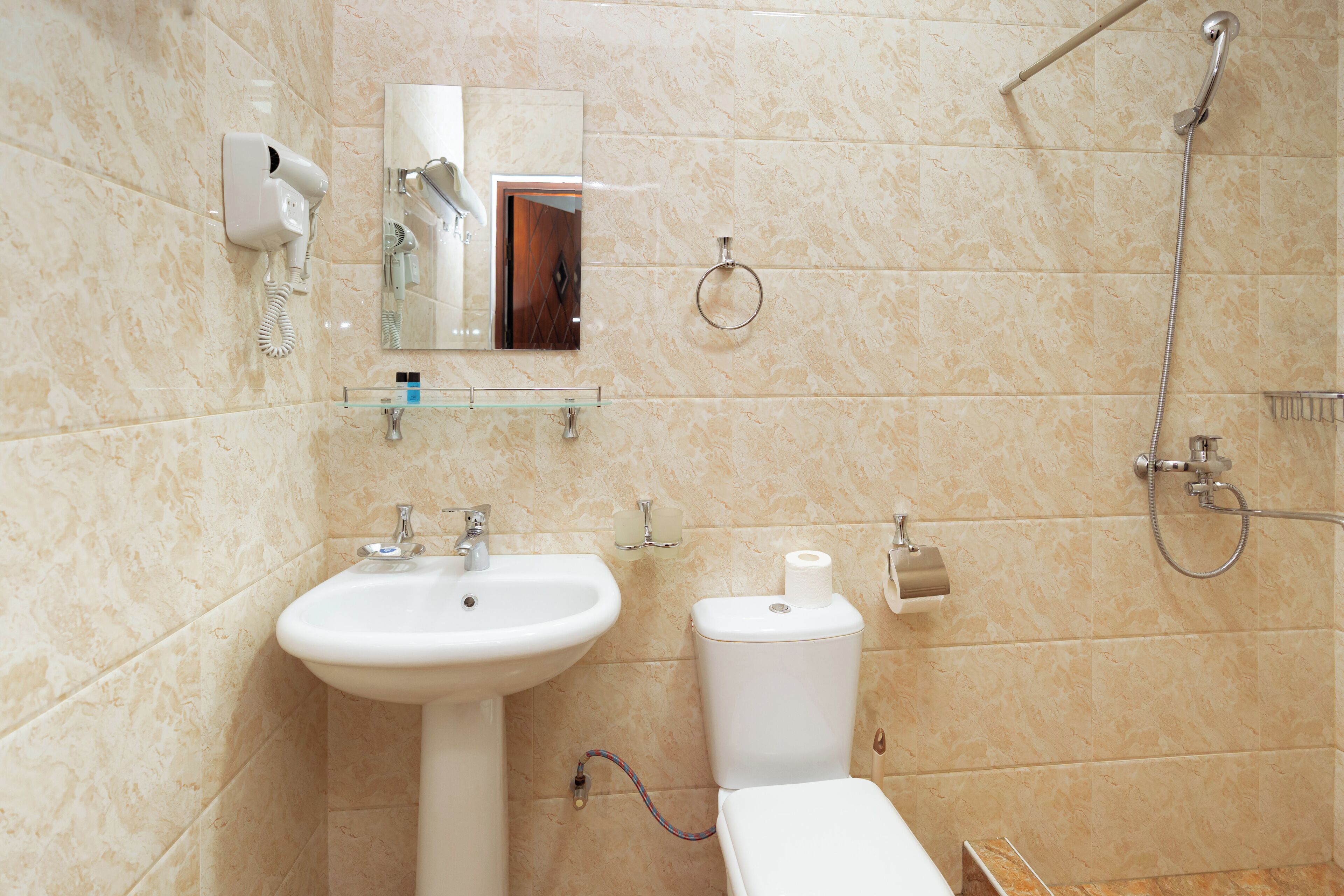 A bathroom with a sink, toilet, and a shower.