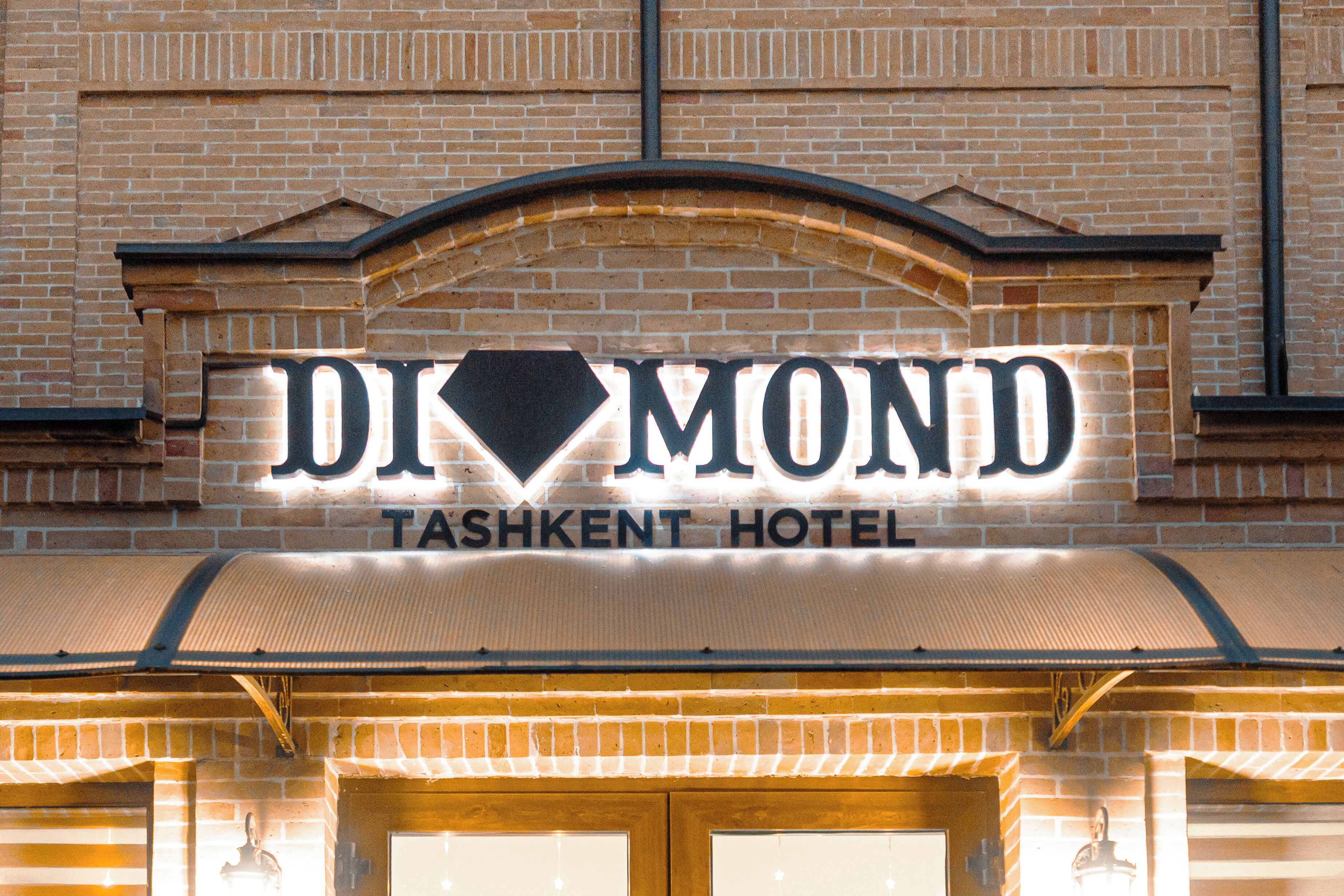 A hotel sign with the name "DIAMOND TASHKENT HOTEL" in capital letters.