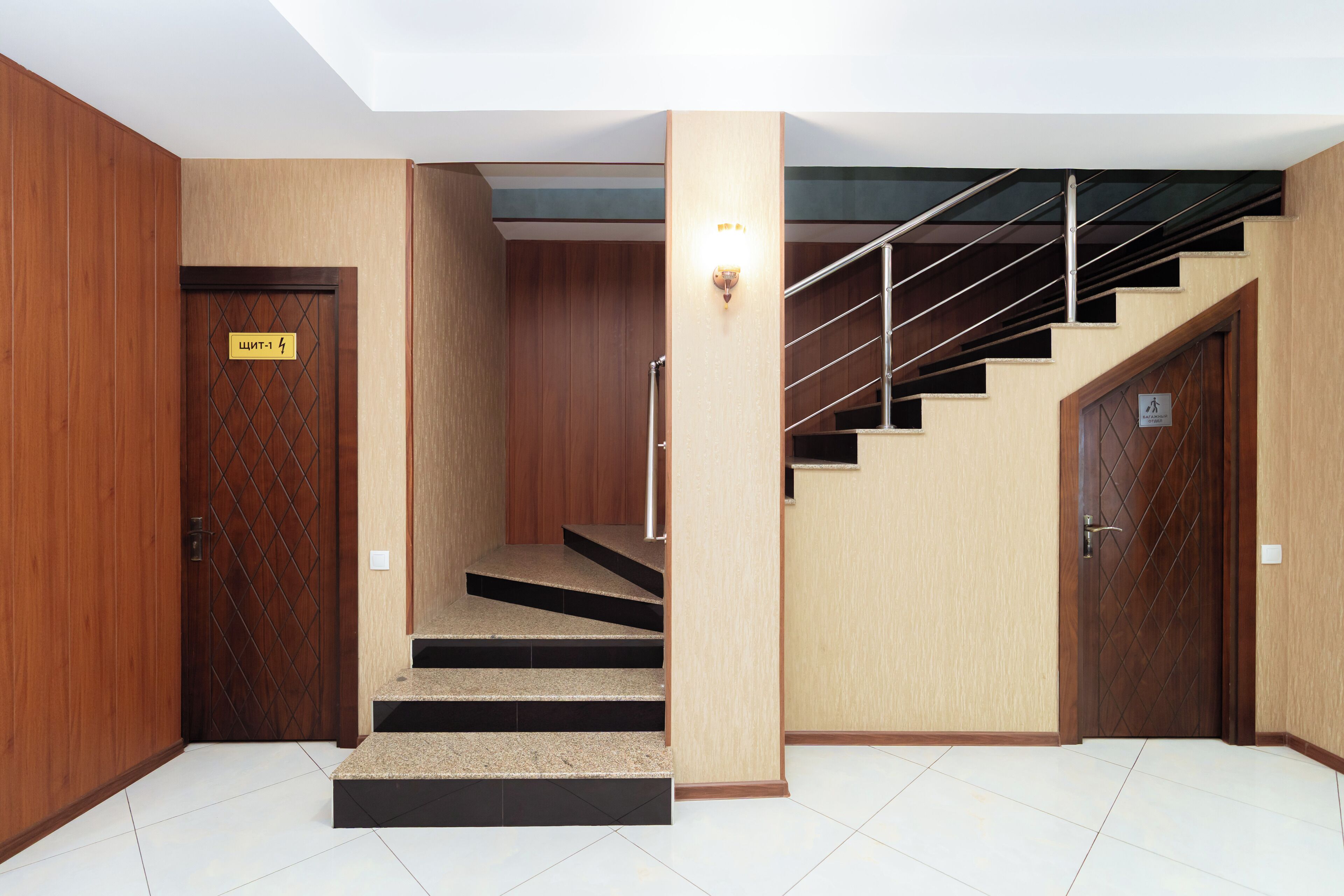 A staircase with a handrail, wooden walls, and a sign indicating room number 4.