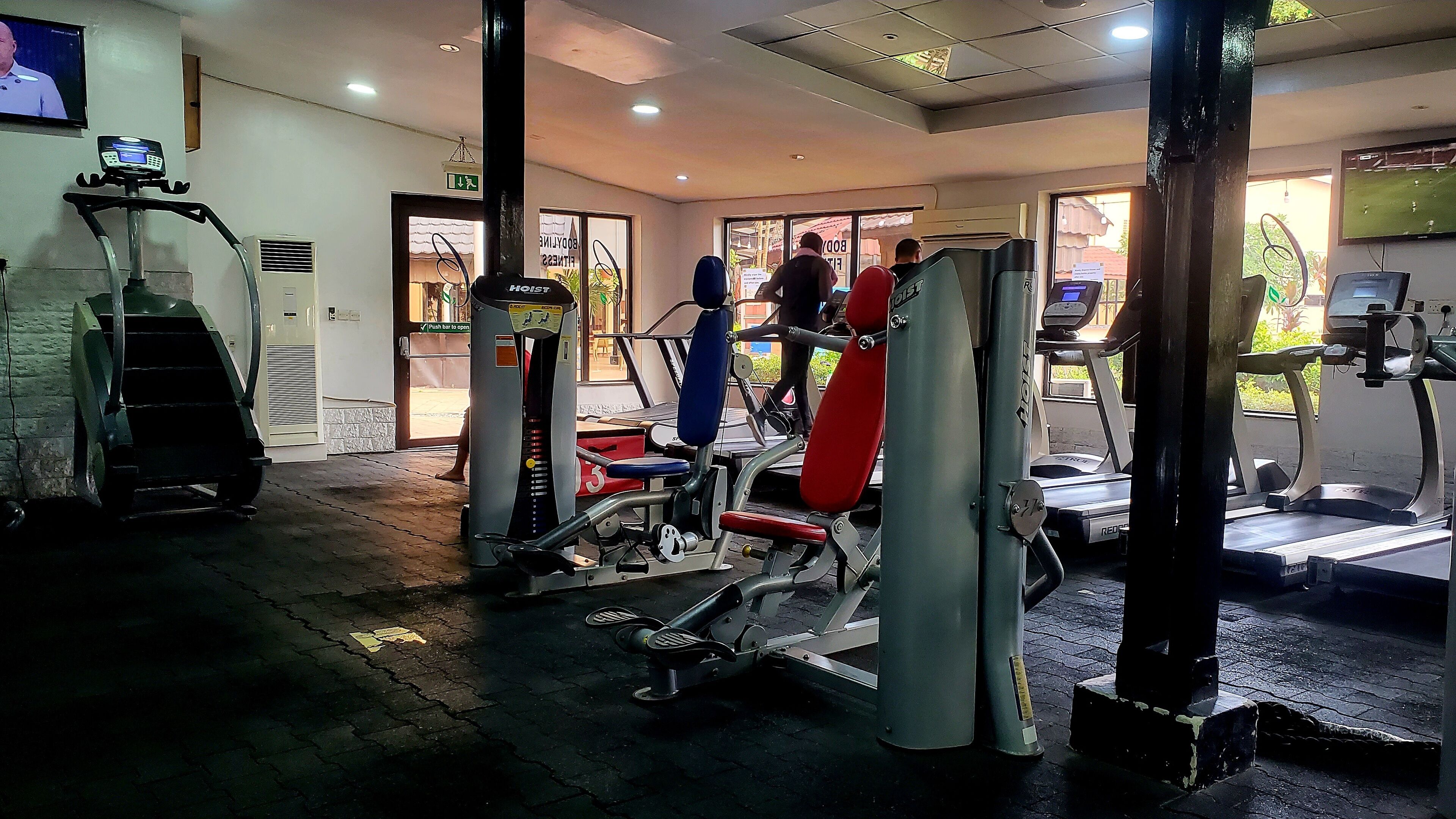 A gym with various exercise equipment, including treadmills and weight machines.