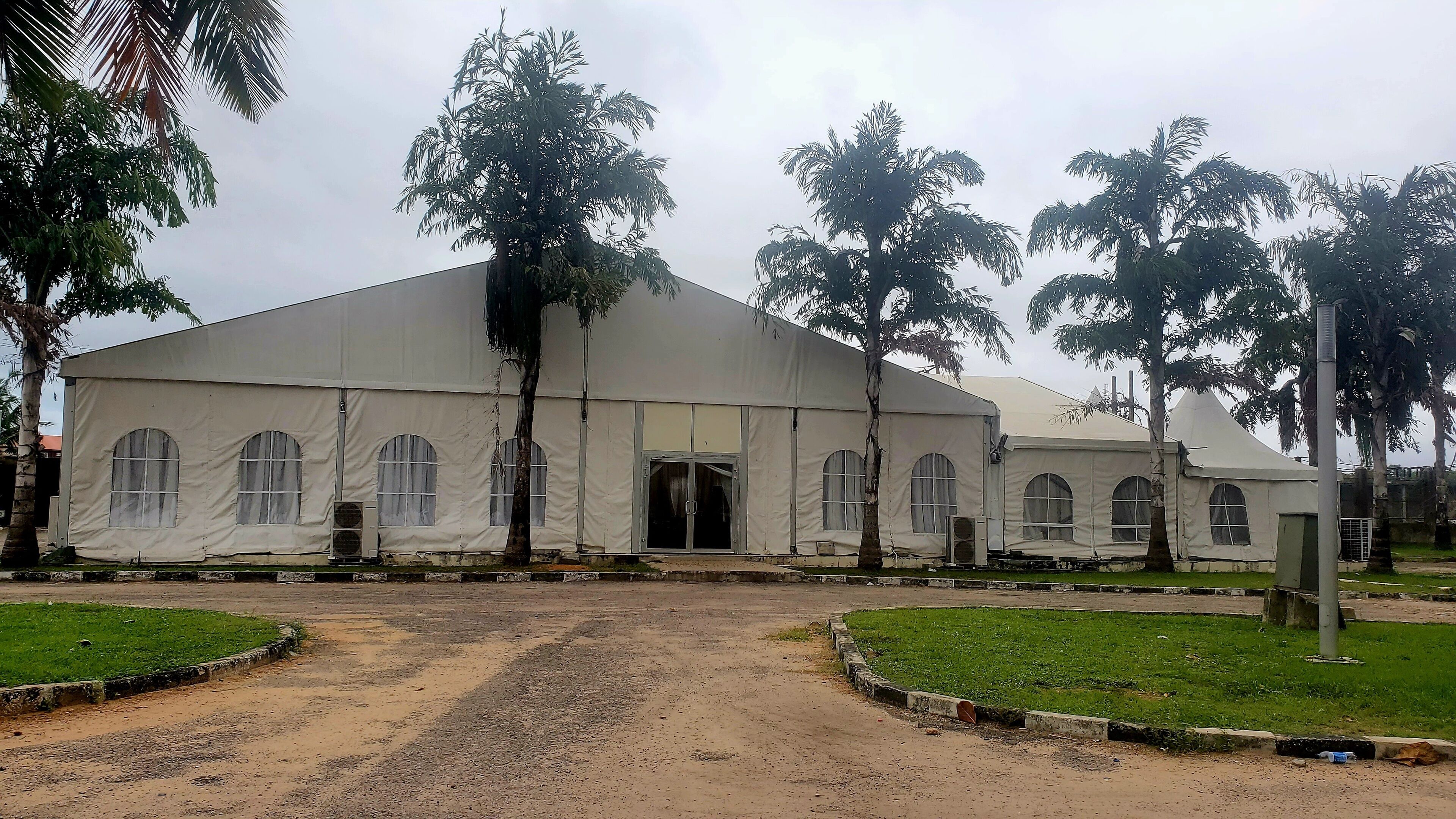 A large, single-story building with a flat roof and multiple arched windows.