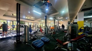 Ein Fitnessstudio mit Laufbändern, Krafttrainingsgeräten und Übungsbällen.