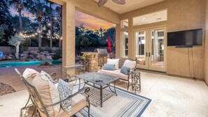 An outdoor patio with a pool, seating area, and a TV mounted on the wall. - Scottsdale Vacation Rental w/ Heated Saltwater Pool, Near Kierland, Golf & Spring Training (Scottsdale)