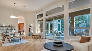 A spacious living area with a large dining table, comfortable seating, and large windows offering views of the outdoors. - Scottsdale Vacation Rental w/ Heated Saltwater Pool, Near Kierland, Golf & Spring Training (Scottsdale)
