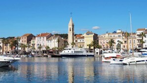 A marina with boats docked, a prominent tower, and buildings with balconies. - La Maison de l'Amiral by Interhome (Sanary sur Mer)