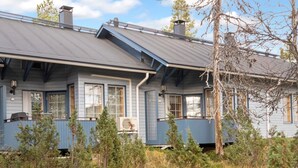 A two-story house with a sloped roof, multiple windows, and a porch area. - Siulapalkinen a 4 by Interhome (Inari)