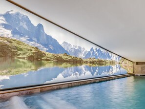 A serene indoor swimming pool with a panoramic view of a mountain lake and peaks. - Champagny-en-Vanoise - Cozy Apt for 8, 3 bdrms, with Wifi (Champagny-en-Vanoise)