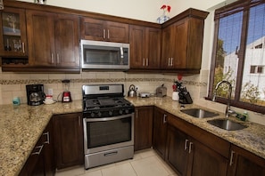 Fridge, cookware/dishes/utensils, dining tables