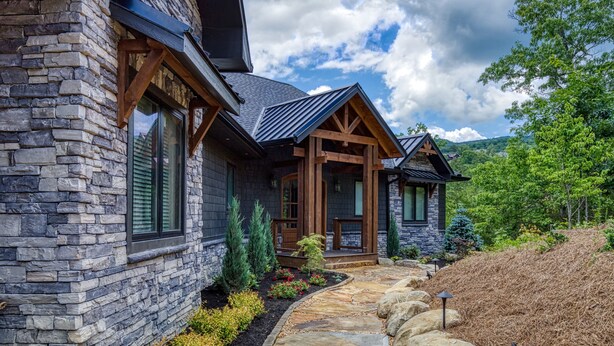 A stone house with a stone pathway leading to the entrance. - Summit Trails Mansion - Luxury Cabin with Views! (Sevierville)