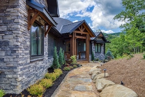 A stone house with a stone pathway leading to the entrance.