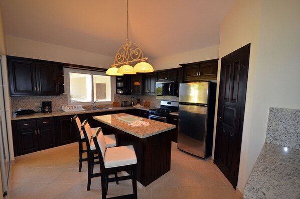 Fridge, cookware/dishes/utensils, dining tables