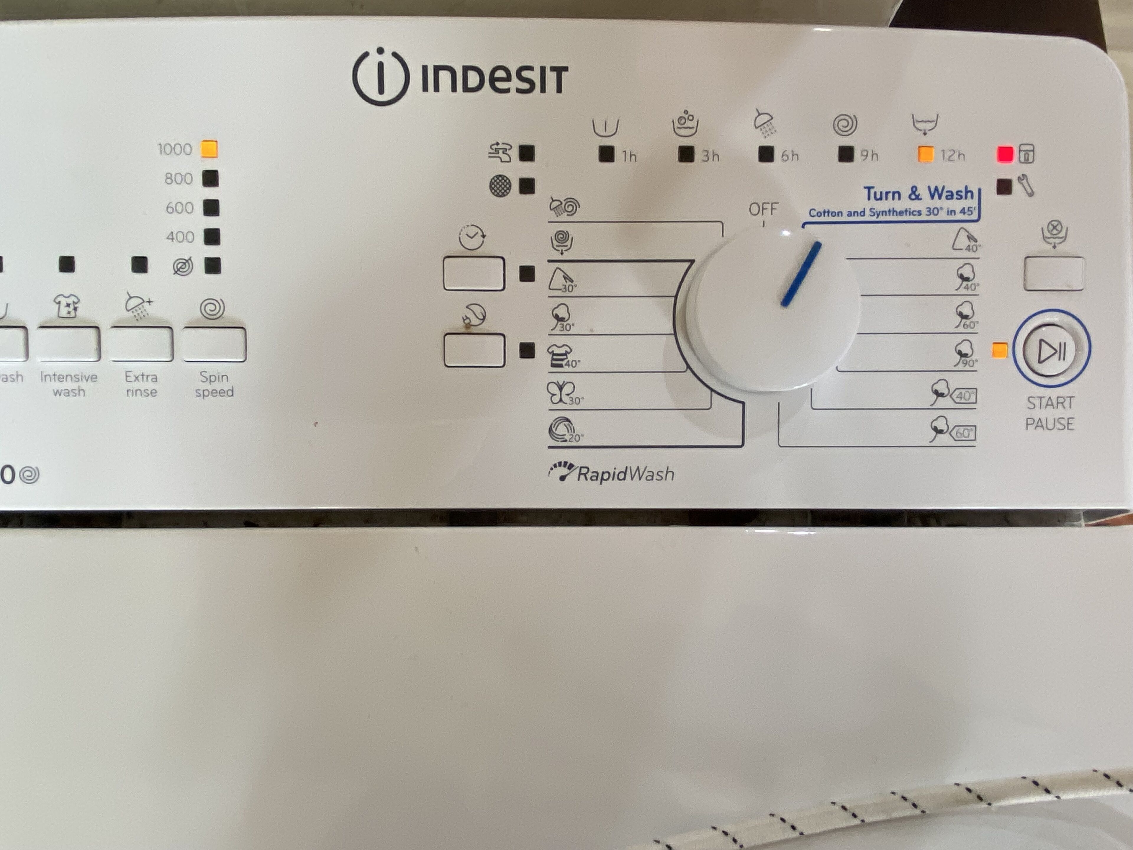 Panel de control de una lavadora Indesit con varias opciones y configuraciones.