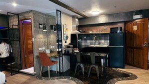 A modern kitchen with a dining area, a built-in oven, and a refrigerator. - Blue Tulip (Lapu-Lapu)