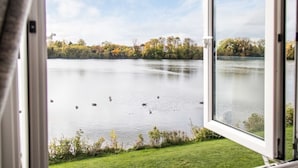A view of a lake with ducks swimming, surrounded by trees and a grassy area. - Spring Lake 14, Lakeside Retreat - Waterside Lodge, Watersports, Sleeps 6 (South Cerney)