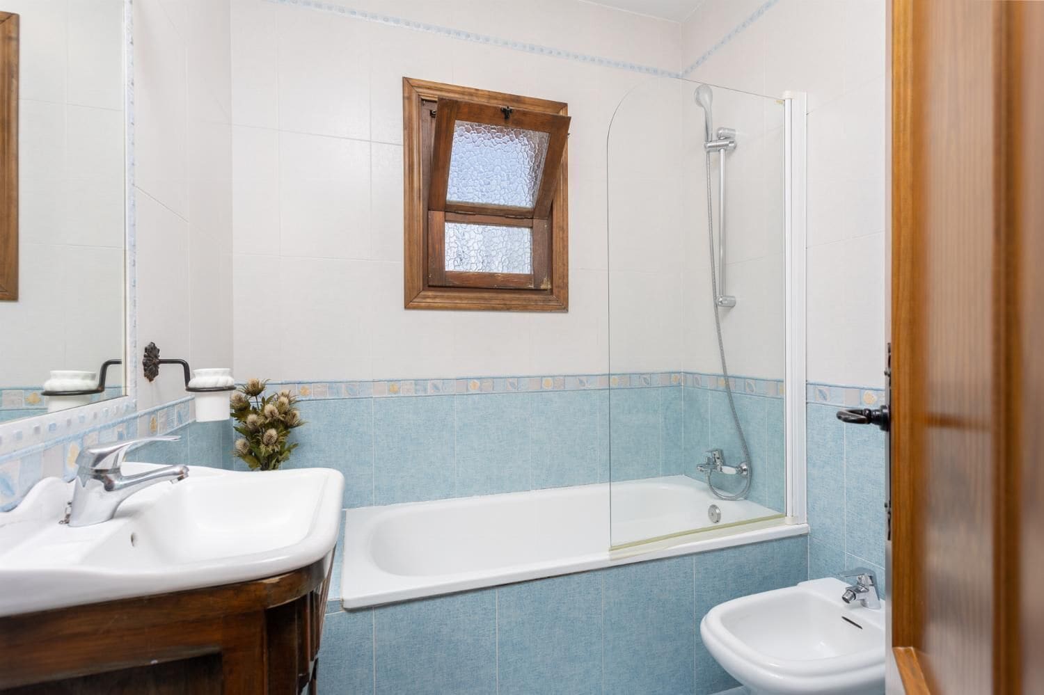 A bathroom with two sinks, a bathtub, and a shower.