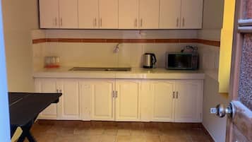 Fridge, microwave, cookware/dishes/utensils, dining tables