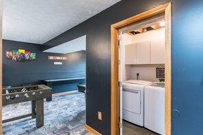 Compact laundry area with two washing machines and a dryer, perfect for convenient household chores.