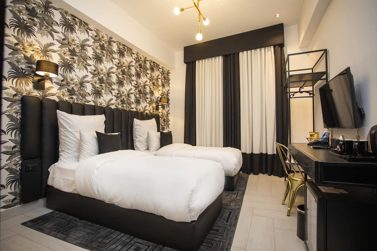Superior Twin Room | Minibar, in-room safe, blackout curtains, iron/ironing board