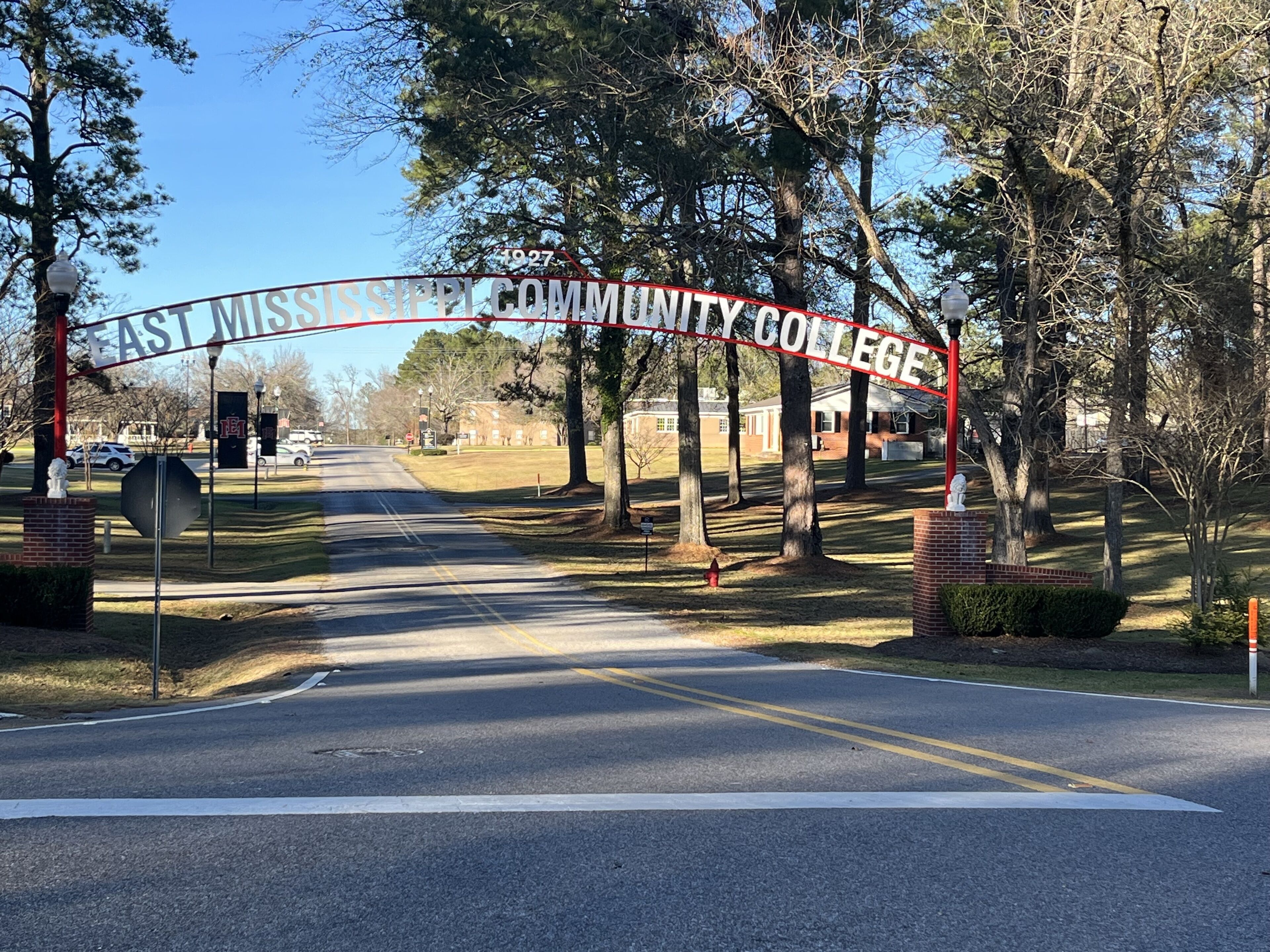 A road leading to East Mississippi Community College with a red archway.
