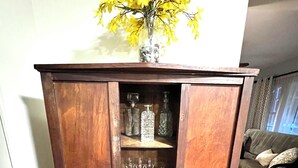 A wooden cabinet with multiple shelves containing glassware and bottles. - Perfect Summer Getaway- 2 bed, large private yard, ravine lot, gameroom (St. Joseph)