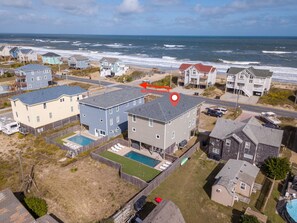 A residential area with houses near the beach, featuring a swimming pool and a view of the ocean. - Steps to the Sand-Ocean Views-Hot Tub/Heated Pool-Putting Green-Coffee Bar (Kitty Hawk)