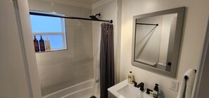 Combined shower/tub, hair dryer, towels, soap