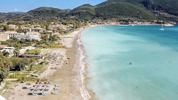 A coastal town with a beach, clear waters, and hills in the background. - Apartment "Apollon" with Sea View, Garden & Wi-Fi (Lefkada)