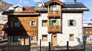 A two-story building with a wooden facade, a balcony, and a solar panel on the roof. - Apartment "Stelo Rosina's Home" (Livigno)