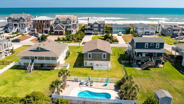 A coastal residential area with houses, a swimming pool, and a view of the ocean. - Impeccable home w/ pool on the desirable Ocean Ridge Drive of Atlantic Beach, NC (Atlantic Beach)