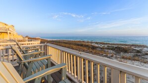 A wooden deck with chairs overlooking a beach. - Gulf Front Townhome, Downtown Destin! (Destin)