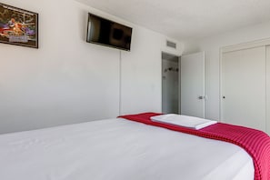 A hotel room with a bed, a shower, and a door. - Bullhead City Home - Near Colorado River! (Bullhead City)