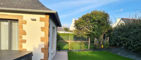 A modern house with a well-maintained lawn and a paved driveway.