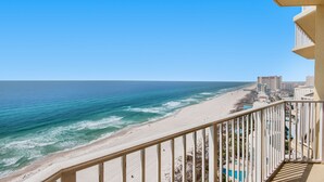 A balcony with a view of a beach and ocean. - 🏖️Lagoon Pool + Tiki Bar - 2BR Boardwalk 1810🏖️ (Panama City Beach)