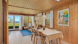 A wooden interior with a dining area, a view of the outdoors, and a large window. - 3 bedroom cozy home in Spøttrup (Spøttrup)