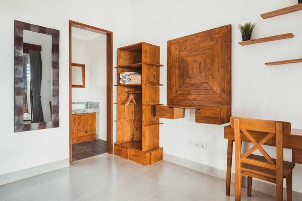 A modern interior with a wooden cabinet, a mirror, and a dining area.