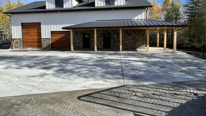 A two-story building with a covered porch and a garage. - Secluded, Cozy Shouse near the Lake!  (Roosevelt)