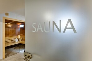 A wall with the word "SAUNA" indicating a sauna area.